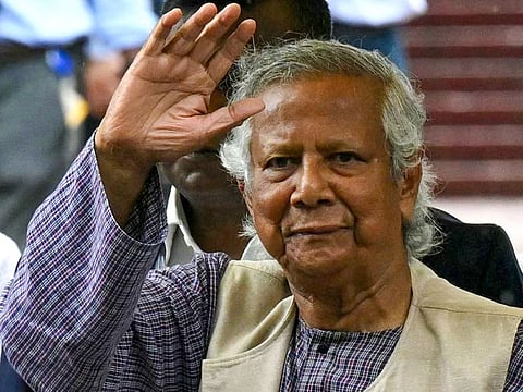 Nobel laureate and chief adviser of Bangladesh's new interim government, Muhammad Yunus greets the public after laying a wreath at the National Martyrs' Memorial in Dhaka.