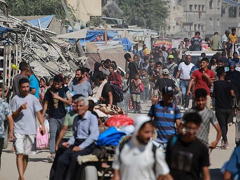 Displaced Palestinians leave an area in east Khan Yunis towards the west, after the Israeli army issued a new evacuation order for parts of the city, in the southern Gaza Strip. 