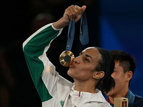 Gold medallist Algeria's Imane Khelif poses on the podium during the medal ceremony for the women's 66kg final boxing category during the Paris 2024 Olympic Games at the Roland-Garros Stadium, in Paris on August 9, 2024. 