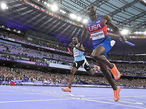 US' Rai Benjamin crosses the finish line ahead of Botswana's Letsile Tebogo in the men's 4x400m relay final of the athletics event at the Paris 2024 Olympic Games at Stade de France in Saint-Denis, north of Paris, on August 10, 2024. 