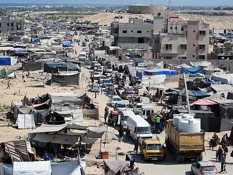 Palestinians flee the Hamad residential district and its surroundings in Khan Younis in the southern Gaza Strip after receiving a warning from the Israeli army to evacuate the area on August 11, 2024.