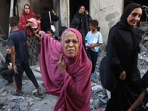 A woman reacts as people inspect the damage following Israeli bombardment in Gaza City's Sheikh Radwan neighbourhood on August 11, 2024.
