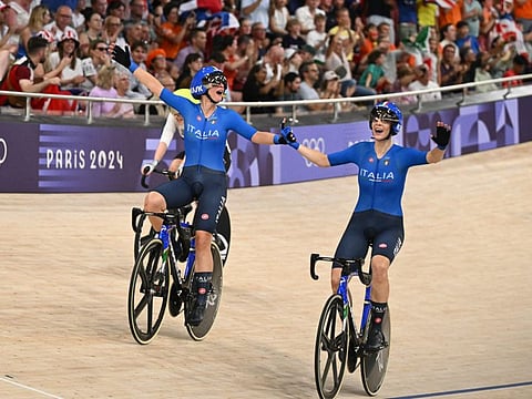 Italy's Chiara Consonni and Vittoria Guazzini celebrate after winning the women's track cycling madison final of the Paris 2024 Olympic Games at the Saint-Quentin-en-Yvelines National Velodrome in Montigny-le-Bretonneux, south-west of Paris, on August 9.