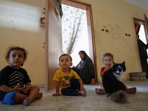 Palestinian children in a hallway at the Asdaa central prison facility which has become a shelter for displaced people in Khan Younis in the southern Gaza Strip on August 14, 2024.