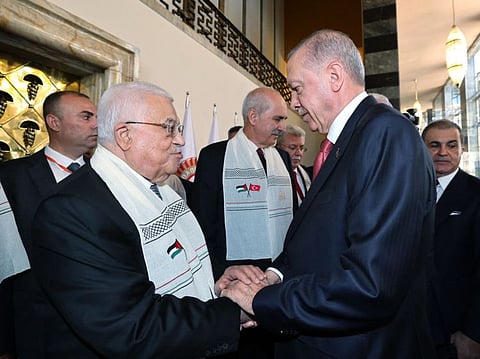 Turkey's President Recep Tayyip Erdogan (right) greets Palestinian Authority president Mahmud Abbas who arrives to deliver a speech at Grand National Assembly of Turkey in Ankara on August 15, 2024.  