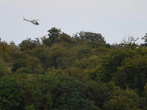 A helicopter from the French Air Force takes part in a search operation in Autreville, eastern France, on August 14, 2024, following a crash between two French military Rafale jets. 
