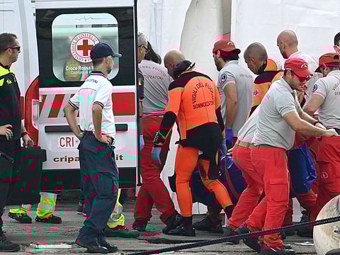 Rescuers carry a body, three days after the British-flagged luxury yacht Bayesian sank.