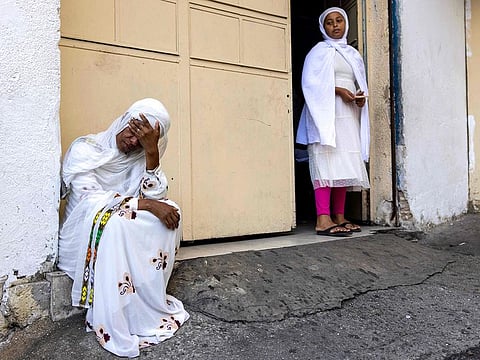 An Eritrean woman reacts near the scene where two men were killed during a street brawl in the Israeli coastal city of Tel Aviv on August 24, 2024. 