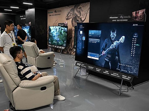 A young man plays Chinese action role-playing game 'Black Myth: Wukong', developed by Chinese video game company Game Science, during its launch day in Shanghai on August 20, 2024. 
