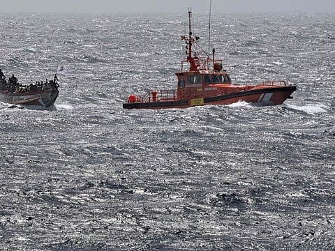 Spanish Salvamento Maritimo (Sea Search and Rescue agency) vessel "Salvamar Adhara" tows a boat with 175 migrant people onboard, half mile off the the coast of Restinga port on the Canary island of El Hierro on August 18, 2024.  Tens of thousands of migrants set off yearly from the Horn of Africa, seeking to escape conflict, natural disasters or poor economic prospects and sailing across the Red Sea in a bid to reach the oil-rich Gulf.