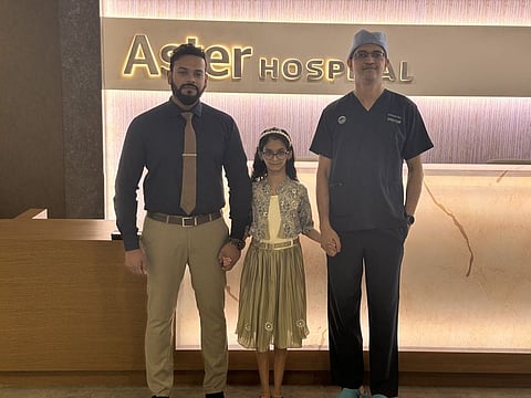 Dr Abhilash Jayachandran, Specialist Laparoscopic and General Surgery, and Dr Sandeep Tandel, Specialist Laparoscopic and General Surgery, Aster Hospital Sharjah, with Devna Anoop, following her successful surgery.