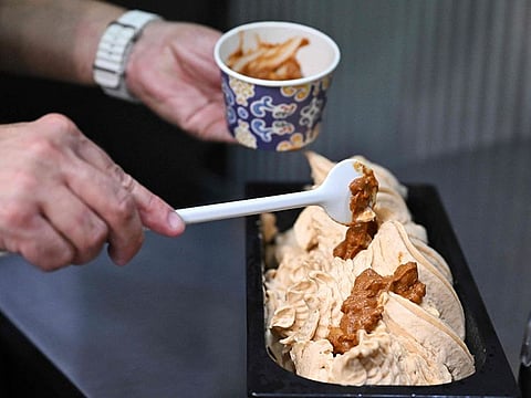 Robert Reinhardt, owner of "Roberto confectionary", prepares his newly created ice cream, the 'Mexican chili beans' at his pastry shop in Tatabanya, north-western Hungary.