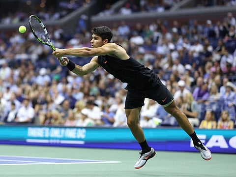 Carlos Alcaraz of Spain returns against Li Tu of Australia during their Men's Singles First Round match on Day Two of the 2024 US Open at the USTA Billie Jean King National Tennis Center on Tuesday.