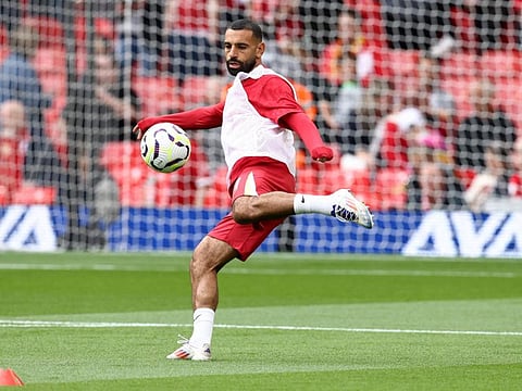 Liverpool's Egyptian striker Mohamed Salah warms up ahead of the English Premier League football match against Brentford at Anfield in Liverpool, north west England on August 25.