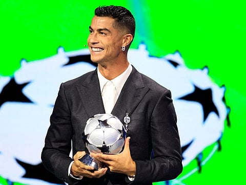 Portugal's national team player and Saudi Al Nassr's forward Cristiano Ronaldo holds his All-Time Goalscorer Award in the Uefa Champions League on stage during the ceremony of the draw for the group stage of the 2024-2025 Uefa Champions League football tournament, at the Grimaldi Forum in Monaco on August 29.