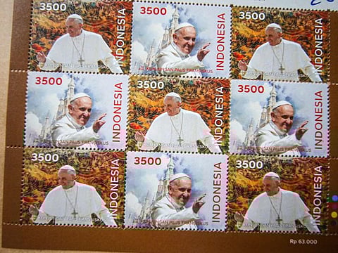 Samples of a new series of stamps ahead of the visit by Pope Francis are seen during the launch ceremony at the Jakarta Cathedral in Jakarta on September 2, 2024.  