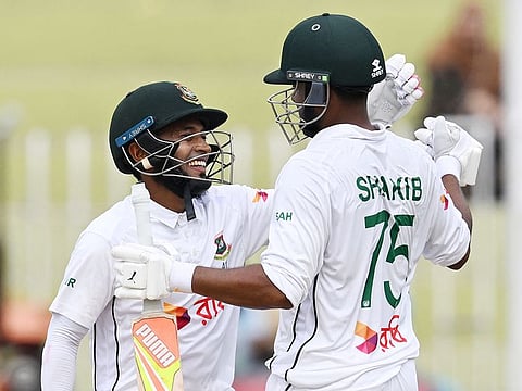Bangladesh's Mushfiqur Rahim (L) and Shakib Al Hasan celebrate after winning the second and last Test cricket match against Pakistan, at the Rawalpindi Cricket Stadium in Rawalpindi on September 3, 2024. 