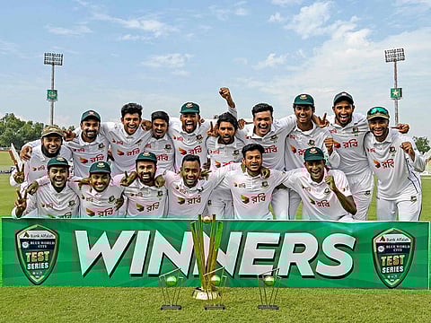 Bangladesh's players celebrate with trophy after winning the second and last Test cricket match against Pakistan, at the Rawalpindi Cricket Stadium in Rawalpindi on September 3, 2024. 