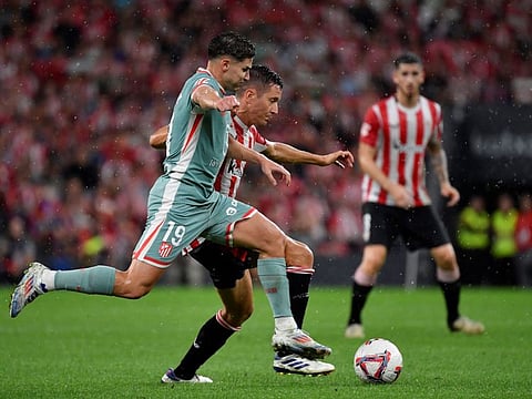 Atletico Madrid's Spanish forward Julian Alvarez (left) vies with Athletic Bilbao's Spanish defender Ander Herrera during the Spanish League football match at the San Mames stadium in Bilbao on August 31.
