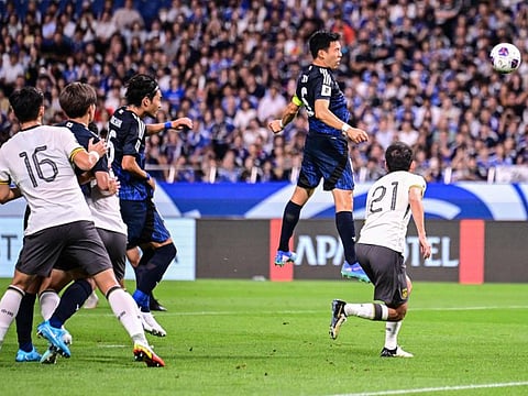 Japans midfielder Wataru Endo (2nd R) heads the ball to score his team's first goal during the third round 2026 World Cup qualifying round football match against China at Saitama Stadium in Saitama, north of Tokyo, on Thursday.