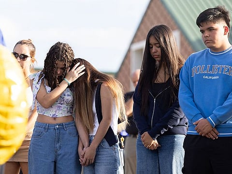 Students and community members pray at a memorial outside of Apalachee High School on September 5, 2024 in Winder, Georgia.