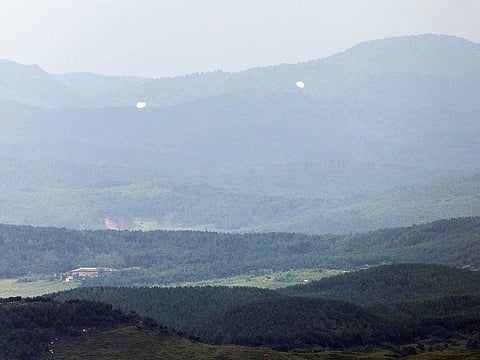 Trash-filled white balloons float in the air over the inter-Korea border as seen from South Korea's Odusan Unification Observatory in Paju on September 5, 2024