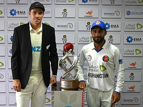New Zealand's captain Tim Southee (left) and his Afghanistan's counterpart Hashmatullah Shahidi unveil the trophy on the eve of their one-off Test cricket match at the Shaheed Vijay Singh Pathik Sports Complex in Greater Noida on Sunday.