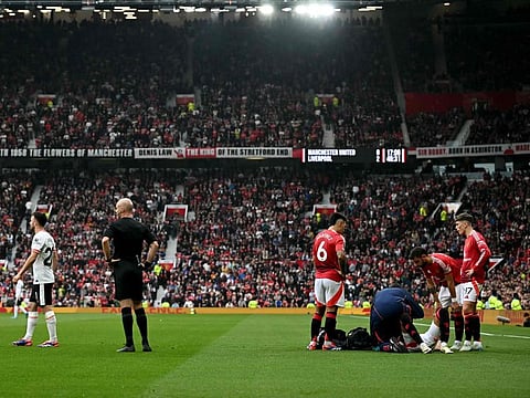 Manchester United's defender Noussair Mazraoui receives medical treatment during the English Premier League football match against Liverpool at Old Trafford in Manchester, north west England, on September 1.