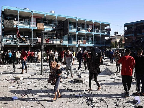 Palestinians walk in the courtyard of the Al Jawni school after an Israeli air strike hit the site, in Nuseirat in the central Gaza Strip on September 11, 2024, amid the ongoing war in the Palestinian territory between Israel and Hamas.
