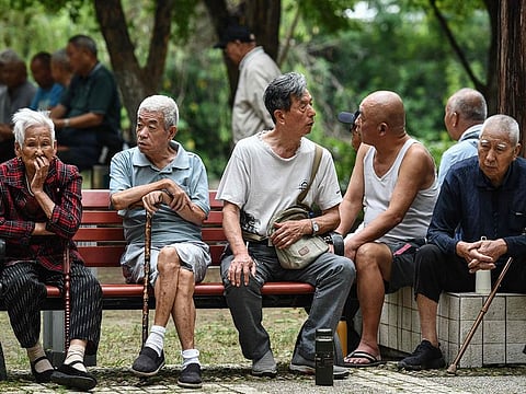 Elderly people rest at a park in Fuyang in eastern China's Anhui province on September 13, 2024. China said on September 13 it would gradually raise its statutory retirement age, as the country grapples with a looming demographic crisis and an older population. 
