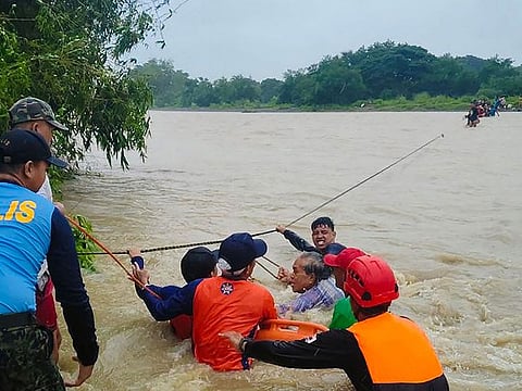 Coast guard personnel and rescue workers evacuating residents as heavy rains triggered flooding brought by Tropical Storm Bebinca.