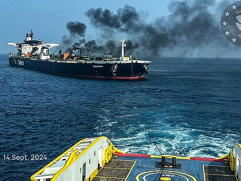 This handout picture provided by EUNAVFOR ASPIDES on September 15, 2024, and dated September 14, shows a vessel with a rope extended toward the Greek-owned oil tanker Sounion as smoke and fire billows from it, off the coast of Hodeida in the Red Sea. 