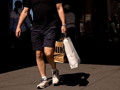 A shopper carries a Nike bag in New York, US, on Friday, Sept. 13, 2024. 