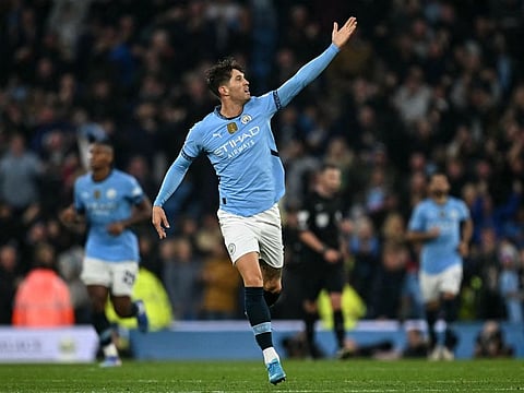 Manchester City's defender John Stones scores the equalising goal during the English Premier League football match against Arsenal at the Etihad Stadium in Manchester, north west England, on Sunday.