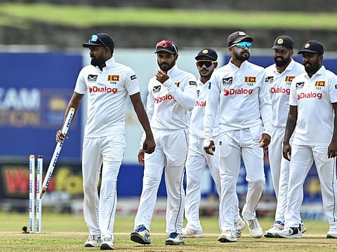 Sri Lanka's players celebrate with teammates after their team's win at the end of the first Test cricket match against New Zealand at the Galle International Cricket Stadium on Monday.