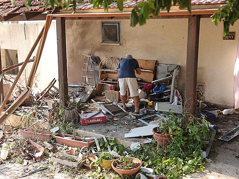 A man inspects the damage at the site of a rocket attack, fired from Lebanon, in Kibbutz Saar, north of Nahariya on September 25, 2024. 