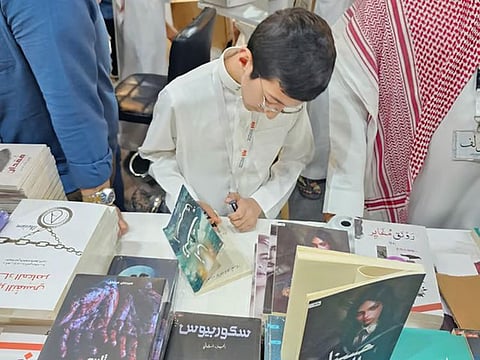 Abdallah Ali signs his book at the Riyadh Book Fair. 