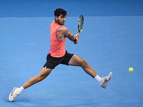 Spains Carlos Alcaraz hits a return to Russia's Karen Khachanov during their mens singles quarter-final match at the China Open tennis tournament in Beijing on September 30, 2024. (Photo by GREG BAKER / AFP)