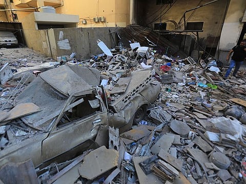 A man inspects the damage at the site of an overnight Israeli strike on Beirut's southern suburb of Ghobeiry on September 30, 2024. 