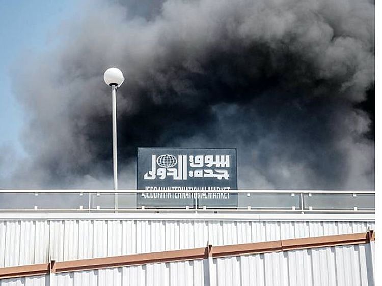 Plumes of smoke rise from the Jeddah market after a fire broke out there Sunday.  