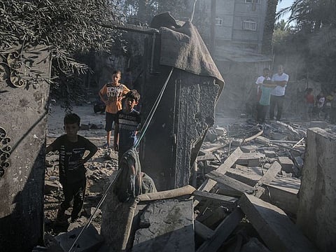 Palestinian children amongst the debris following an Israeli airstrike in Deir Al Balah, central Gaza, on Friday, October 4, 2024.  