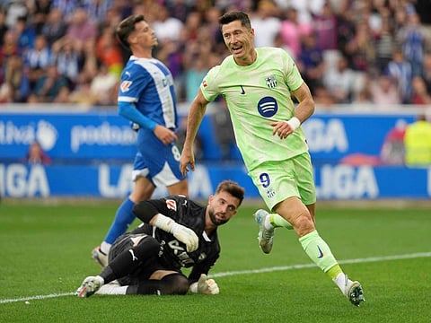 Barcelona's Polish forward Robert Lewandowski celebrates scoring his team's second goal during the Spanish league football match against Deportivo Alaves at the Mendizorroza stadium in Vitoria on Sunday.