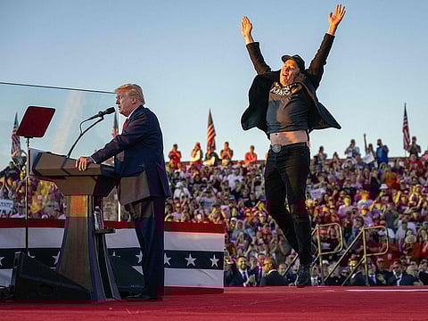 File photo: Tesla CEO Elon Musk (R) jumps on stage as he joins Donald Trump during a campaign rally. In addition to his usual title of the world's richest man, Democrats are now describing him as "President Musk."