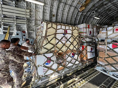 Humanitarian aid to Lebanon provided by Qatar and France is loaded onto a Qatari military aircraft at Al-Udeid airbase southwest of Doha.