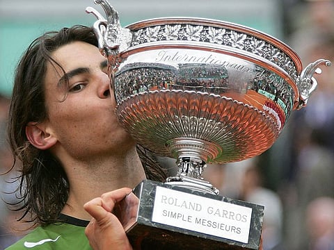 Spaniard Rafael Nadal kisses his trophy after winning the French Open final against Argentinian Mariano Puerta at Roland Garros in 2005.
