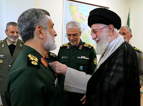 Iran's Supreme Leader Ayatollah Ali Khamenei decorating the Islamic Revolutionary Guard Corps' Aerospace Force Commander Brigadier General Amir Ali Hajizadeh with the 'Fath' badge in Tehran for planning the Iranian attack on Israel on October 6, 2024. 