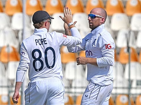 England's Jack Leach (right) celebrates with captain Ollie Pope after dismissing Pakistan's Salman Agha during the fifth and last day of the first Test in Multan on Friday.