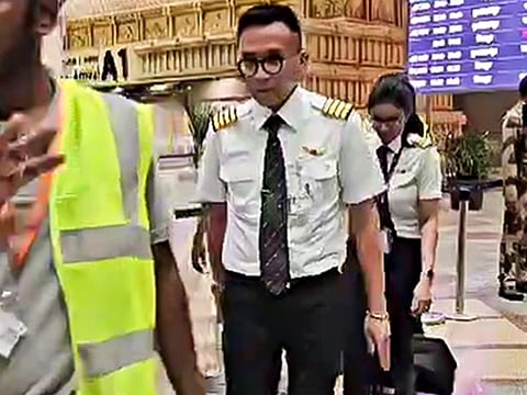 Crew members of Air India Express Flight IX 613 leave from Tiruchirapalli airport after it landed following a snag, on Friday.