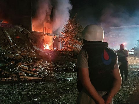 A person stands by damages at the site of an Israeli airstrike that targeted the southern Lebanese city of Nabatiyeh.
