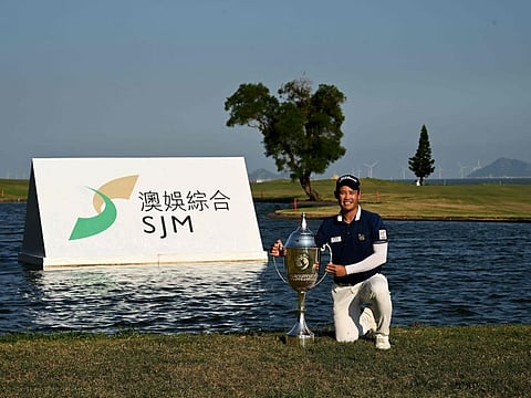 Rattanon Wannasrichan of Thailand posing with the trophy after winning in the Macau Open golf event at the Macau Golf and Country Club on Sunday.